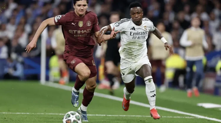 Manchester City's Uzbek defender #45 Abdukodir Khusanov (L) challenges Real Madrid's Brazilian forward #07 Vinicius Junior during the UEFA Champions League knockout phase play-off football match between Real Madrid CF and Manchester City at the Santiago Bernabeu stadium in Madrid on February 19, 2025. (Photo by OSCAR DEL POZO / AFP) (AFP/OSCAR DEL POZO)